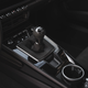 A black seven-speed manual transmission shifter on a 2023 Porsche 911 Carrera T.